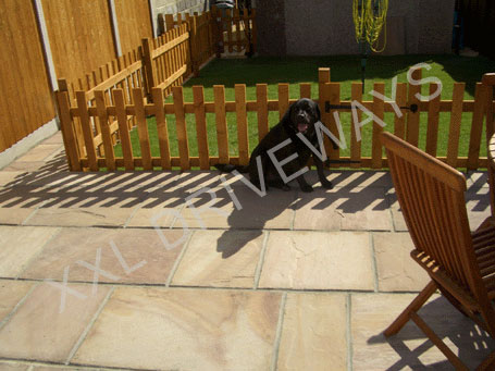 Indian stone patio and path, lawn with picket fence and gate, fence and back gate to rear garden.
